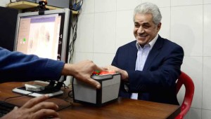 Hamdeen Sabahi has his hand print scanned as he registers his candidacy for president at an election office in Cairo, Egypt, on Thursday, April 3, 2014. (AP Photo/Ahmed Omar)