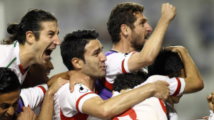 In this June 4, 2013, file photo, Iranian players celebrate after scoring the first goal during their 2014 World Cup Asian zone qualifying match between Qatar and Iran at the Al-Sadd stadium in Doha. (AP Photo/Osama Faisal, File)