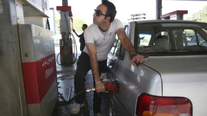An Iranian man fills his car in a gas station in central Tehran, Iran, on Friday, April 25, 2014. (AP Photo/Vahid Salemi)