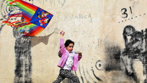 An Iranian girl runs with a kite during the ancient festival of Sizdeh Bedar, an annual public picnic day on the 13th day of the Iranian new year, west of Tehran, Iran, on April 2, 2014. Sizdeh Bedar, which comes from the Persian words for “thirteen” and “day out,” is a legacy from Iran’s pre-Islamic past that hardliners in the Islamic Republic never managed to erase from calendars. (AP Photo/Ebrahim Noroozi)