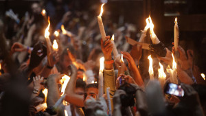 Christian pilgrims hold candles at the church of the Holy Sepulcher, traditionally believed to be the burial site of Jesus Christ, during the ceremony of the Holy Fire in Jerusalem's Old City on Saturday, April 19, 2014. (AP Photo/Dan Balilty)