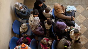 In this Wednesday, December 18, 2013, file photo, Syrian women wait with their children at the UN refugee agency's registration center in Zahleh, in Lebanon's Bekaa Valley. (AP Photo/Maya Alleruzzo, File)