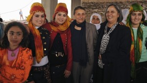Pro-Kurdish Peace and Democracy Party (BDP) mayoral candidate for Diyarbakir city Gultan Kisanak (2nd R) and candidate for Baglar neigborhood Birsen Kaya Akat (4th L) pose with local women during an election campaign in Diyarbakir on February 26, 2014. (REUTERS/Stringer)