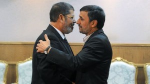 Iranian President Mahmoud Ahmadinejad (R) welcomes his Egyptian counterpart Mohamed Morsi during a meeting on the sidelines of the Non-Aligned Movement summit in Tehran on August 30, 2012 . (SAJAD SAFARI/AFP/GettyImages)