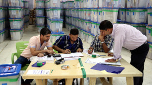 Iraqi electoral workers count ballots at a counting center in Baghdad, Iraq, on Wednesday, May 14, 2014. (AP Photo/ Karim Kadim)