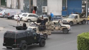 In this image, made from video provided by the Libyan national army via AP Television, shows Tripoli joint security forces on vehicles with heavy artillery standing guard near the Libyan parliament on May 18, 2014. (AP Photo/Libyan national army)