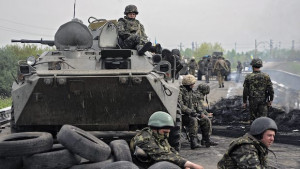 Ukrainian soldiers stay near of a checkpoint seized by them not far of Slaviansk, Ukraine, on May 2, 2014. (EPA/ROMAN PILIPEY)
