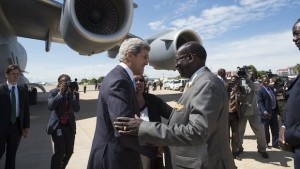 South Sudanese Foreign Minister Barnaba Marial Benjamin (C-R) greets US Secretary of State John Kerry (C-L) upon his arrival at Juba international airport on May 2, 2014. (AFP PHOTO / POOL / Saul LOEB)