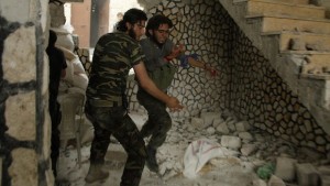 A Free Syrian Army fighter helps his wounded fellow fighter in Al-Amariya district in Aleppo on May 8, 2014. (REUTERS/Ammar Abdullah)