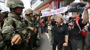 Thai activists shout slogans to soldiers during a rally against the military coup at a cinema in Bangkok, Thailand, on May 24, 2014. (EPA/RUNGROJ YONGRIT)
