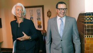 Moroccan Minister of Finance Mohamed Boussaid (R), chats with International Monetary Fund Managing Director Christine Lagarde (L) as they walk before a meeting in the Ministry of Finance in Rabat on May 8, 2014. (AP Photo/Abdeljalil Bounhar)