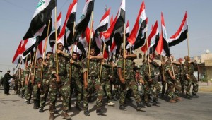Volunteers of the newly formed "Peace Brigades" participate in a parade in the Shiite stronghold of Sadr City, Baghdad, Iraq, Saturday, June 21, 2014. (AP Photo/Karim Kadim)