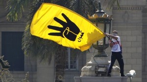 A student supporter of the Muslim Brotherhood and ousted Egyptian President Mohamed Mursi waves the yellow flag bearing the four-fingered Rabaa sign during a demonstration outside Cairo University on May 14, 2014. (REUTERS/Mohamed Abd El Ghany)