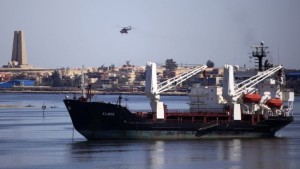 A military helicopter flies above a container ship in the Suez canal near Ismailia port city, northeast of Cairo, on May 2, 2014. (REUTERS/Amr Abdallah Dalsh)