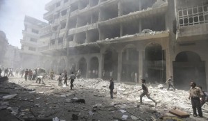 Residents run in a damaged site due to what activists claim was shelling by forces loyal to Syrian President Bashar Al-Assad at a market in central Duma, in Eastern Ghouta, on June 15, 2014. (REUTERS/Bassam Khabieh)