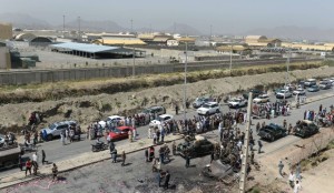 Afghan security forces and locals gather at the site of an attack by the Taliban on Kabul International Airport on July 17, 2014.(AFP Photo/Shah Marai)
