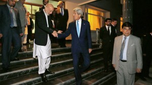 Afghanistan's President Hamid Karzai, left, shakes hands with US Secretary of State John Kerry as he sends him off after a dinner at the presidential palace in Kabul, Afghanistan, on July 11, 2014. (AP Photo/Jim Bourg, Pool)