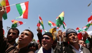 Iraqi Kurdish protesters wave the flag of their autonomous Kurdistan region during a demonstration for independence on July 3, 2014, outside the Kurdistan parliament building in Erbil(AFP PHOTO/SAFIN HAMED)