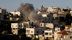 Smoke rises from the family home of Palestinian Ziad Awad in the town of Idna, 8 miles (13 kilometers) west of the West Bank city of Hebron, on Wednesday, July 2, 2014. (AP Photo/Nasser Shiyoukhi)