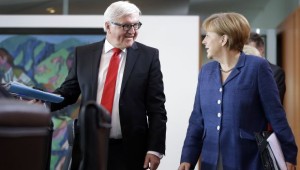 German Chancellor Angela Merkel (R) and German Foreign Minister Frank-Walter Steinmeier (L) arrive for the weekly cabinet meeting at the chancellery in Berlin, Germany, on July 9, 2014. (AP Photo/Michael Sohn)