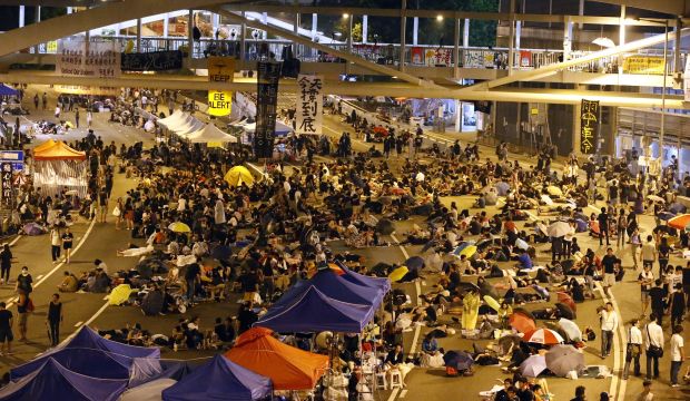 Protesters to lift Hong Kong government blockade, vow to stay in Central