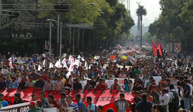 Thousands march in Mexico to demand action over massacre