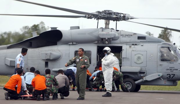 AirAsia hunt finds bodies in seats as weather hampers search