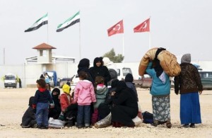 Internally displaced Syrians wait near the Bab al-Salam crossing, opposite the Turkey's Kilis province