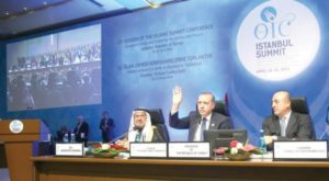 Erdogan while chairing the final session of the OIC Istanbul summit, with OIC Secretary General Iyad Madani to his left.