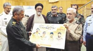 Iranian Army commader Salehi holding a poster of dead Iranian Army soldiers, who died in Syria , showing it to IRGC commander (Defense Press Website)