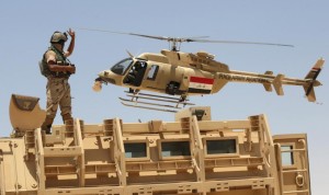 Iraqi helicopter flies over soldier in Husaybah, in Anbar province