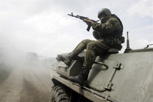A member of Russia’s special police, OMON, sits on an armored vehicle during a drill in the southern Russian city of Stavropol on May 30, 2008