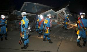 Police officers check collapsed house after an earthquake in Mashiki town, Kumamoto prefecture, southern Japan