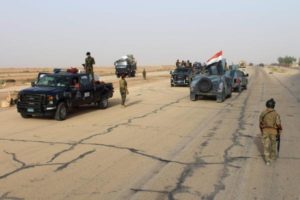 Iraqi government forces gather on the highway between the city of Ramadi and the town of Rutba