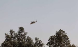 An Algerian military helicopter flies over Amenas city
