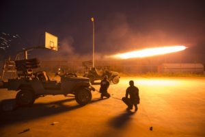 Shi’ite fighters fire a rocket during clashes with ISIS militants in Salahuddin province.