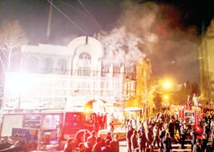 Smoke rises as Iranian protesters set fire to the Saudi embassy in Tehran on Jan 3
