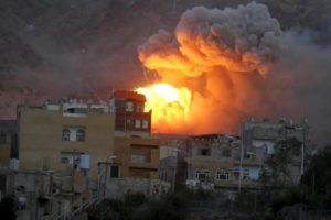 Fire and smoke billows from an army weapons depot after it was hit by an air strike in Yemen's capital Sanaa