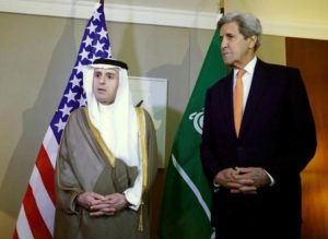 Saudi Foreign Minister al-Jubeir talks next to US Secretary of State Kerry during a meeting on Syria in Geneva