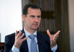 Head of Syrian Regime Bashar al-Assad speaks during an interview with Russia's RIA news agency