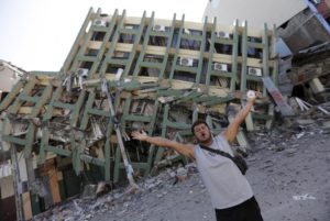 A resident gestures next to a collapsed building after an earthquake struck off the Pacific coast, in Portoviejo, Ecuador, April 18, 2016. REUTERS/Henry Romero