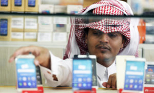 A vendor displays mobile phones at a shop in Riyadh, Saudi Arabia