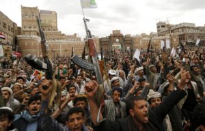 Shi’ite Muslim rebels hold up their weapons during a rally against air strikes in Sanaa, Yemen, March 26, 2015.