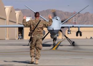 A U.S. airman guides a U.S. Air Force MQ-9 Reaper drone as it taxis to the runway at Kandahar Airfield, Afghanistan March 9, 2016. REUTERS/Josh Smith/Files