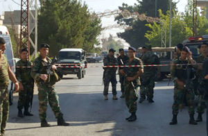Lebanese army soldiers secure the area near the site where suicide bomb attacks took place in the Christian village of Qaa, in the Bekaa valley