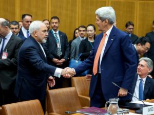 Foreign Minister of Iran, Mohammad Javad Zarif shakes hands with US Secretary of State John Kerry at the last working session of nuclear negotiations on July 14, 2015 in Vienna, Austria.