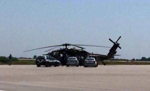 Caption: Greek police vehicles next to a Turkish military helicopter at Alexandroupolis airport, after it landed there carrying eight officers seeking asylum after a coup bid in Turkey, on July 16, 2016 (AFP Photo/)