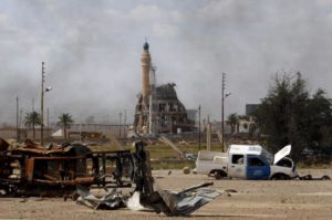 A damaged mosque is seen amidst destroyed vehicles and other debris in Tikrit, Iraq, April 1, 2015. The Iraqi government claimed victory over Islamic State insurgents in Tikrit on Wednesday after a month-long battle for the city supported by Shi'ite militiamen and U.S.-led air strikes, saying that only small pockets of resistance remained.
