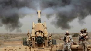 Saudi soldiers fire artillery toward three armed vehicles approaching the Saudi border with Yemen in Jazan, Saudi Arabia, Monday, April 20, 2015.