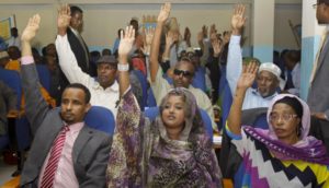 Somalia lawmakers raise their hands during a confidence vote on Prime Minister Abdiweli Sheikh Ahmed, at the Parliament Building in Mogadishu, Somalia,